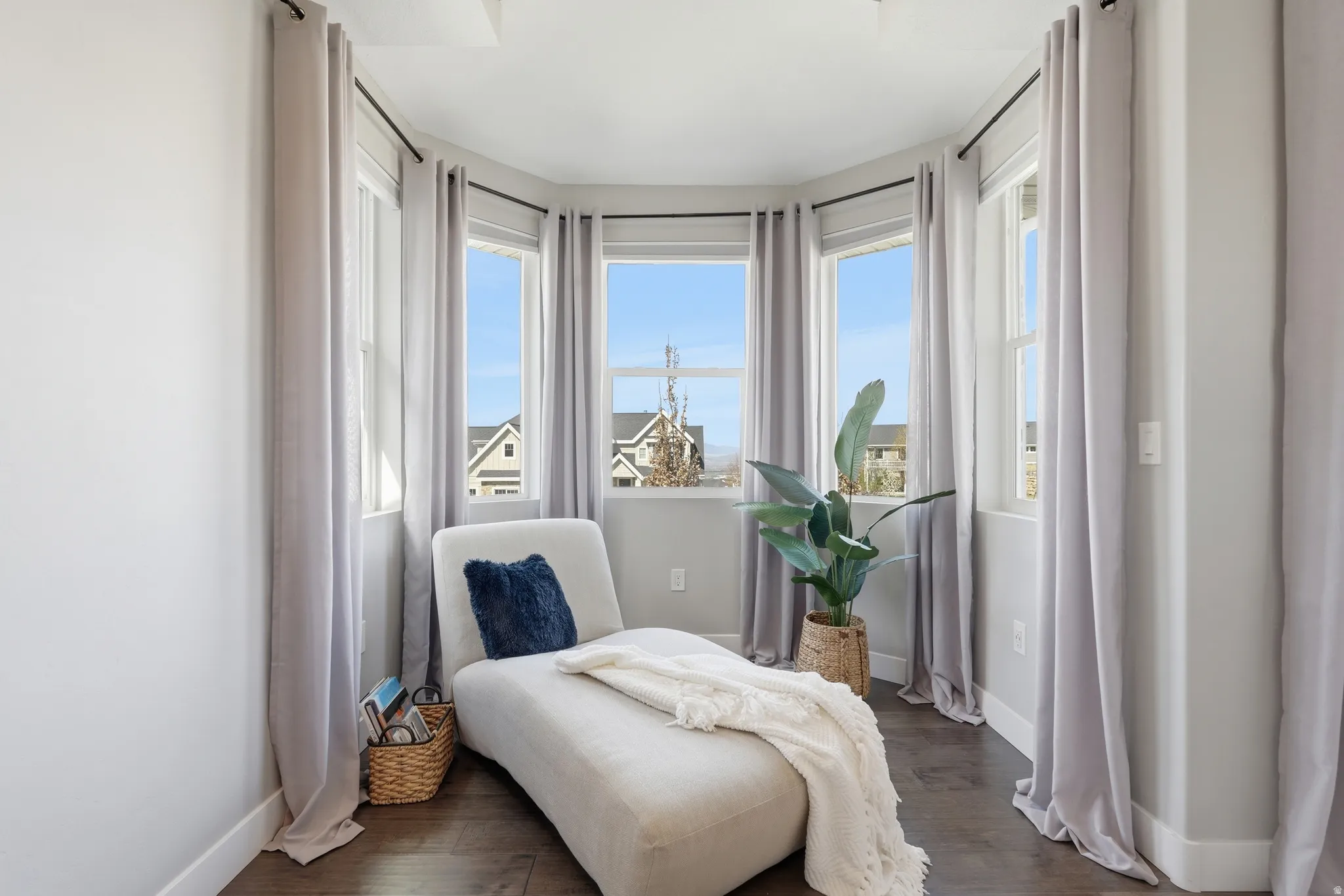Sitting area in the primary bedroom with natural lighting