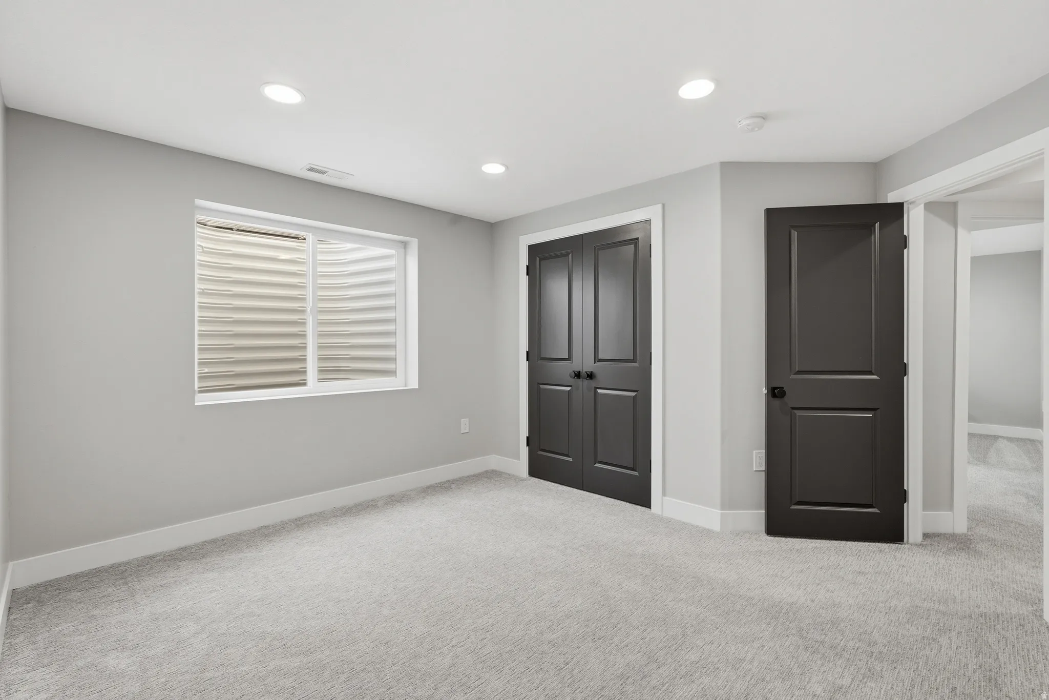 Unfurnished bedroom featuring carpet flooring, a closet, and recessed lighting