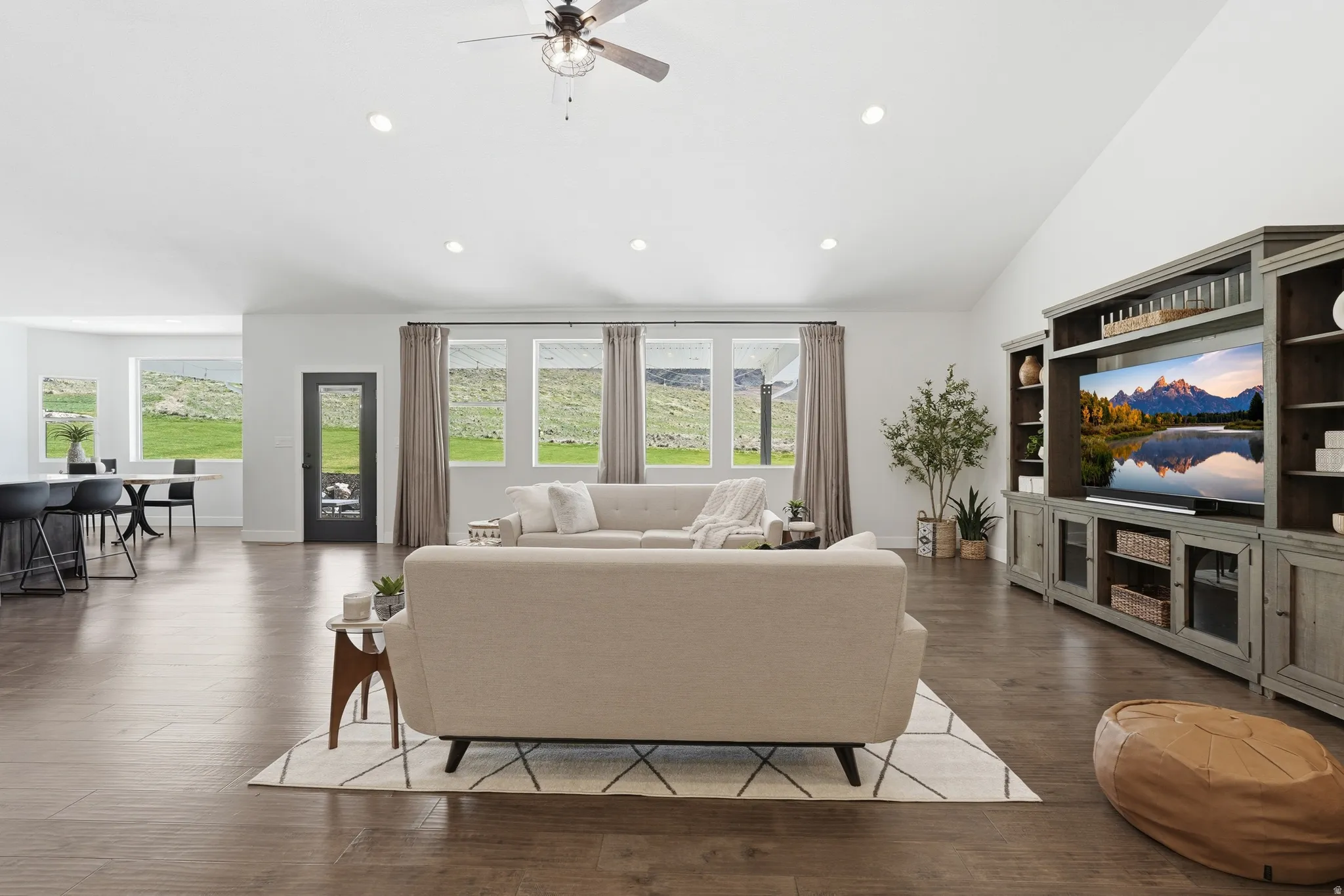 Living area with hardwood flooring, ceiling fan, recessed lighting, and vaulted ceiling