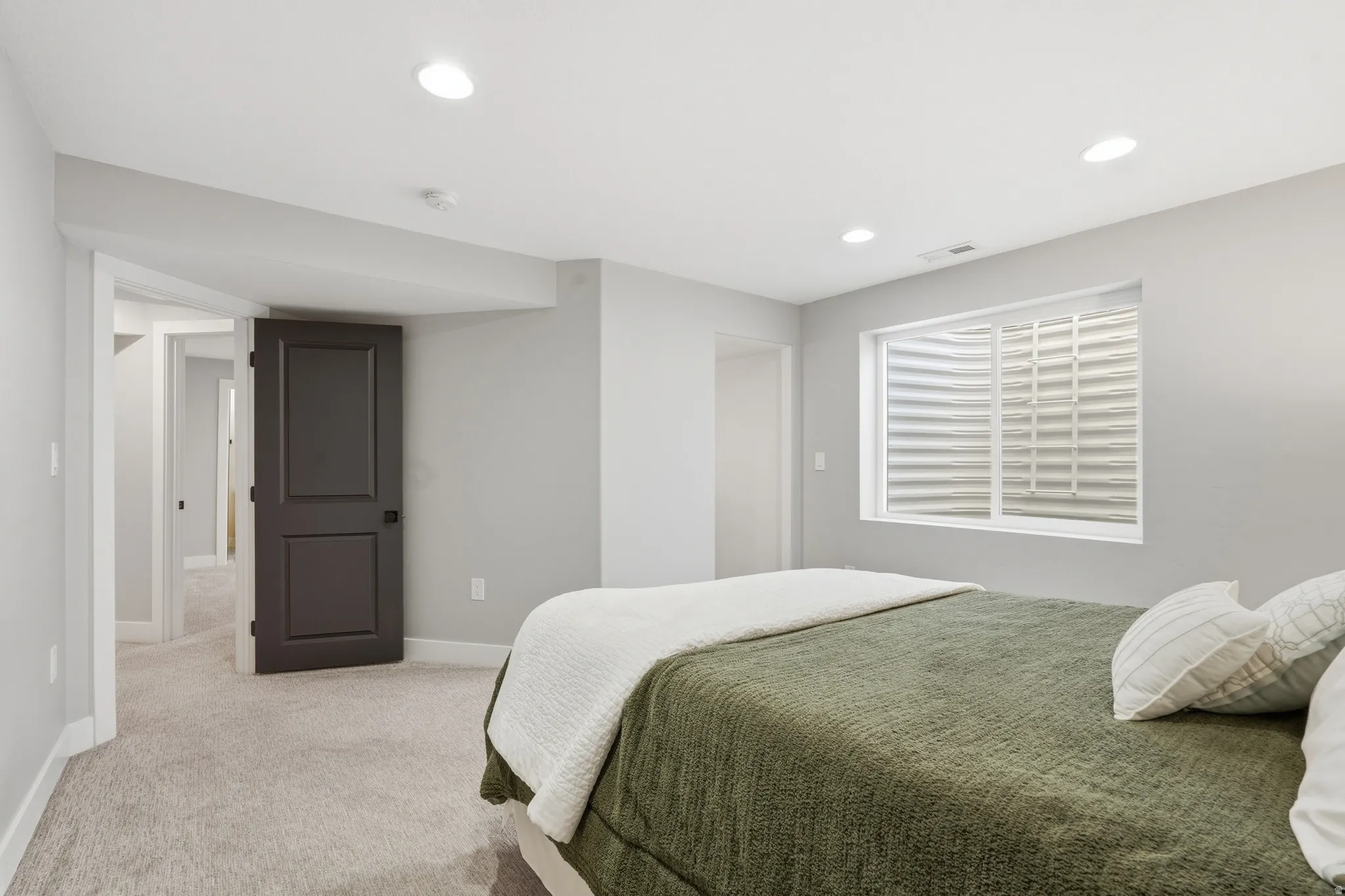Bedroom featuring light carpet and recessed lighting