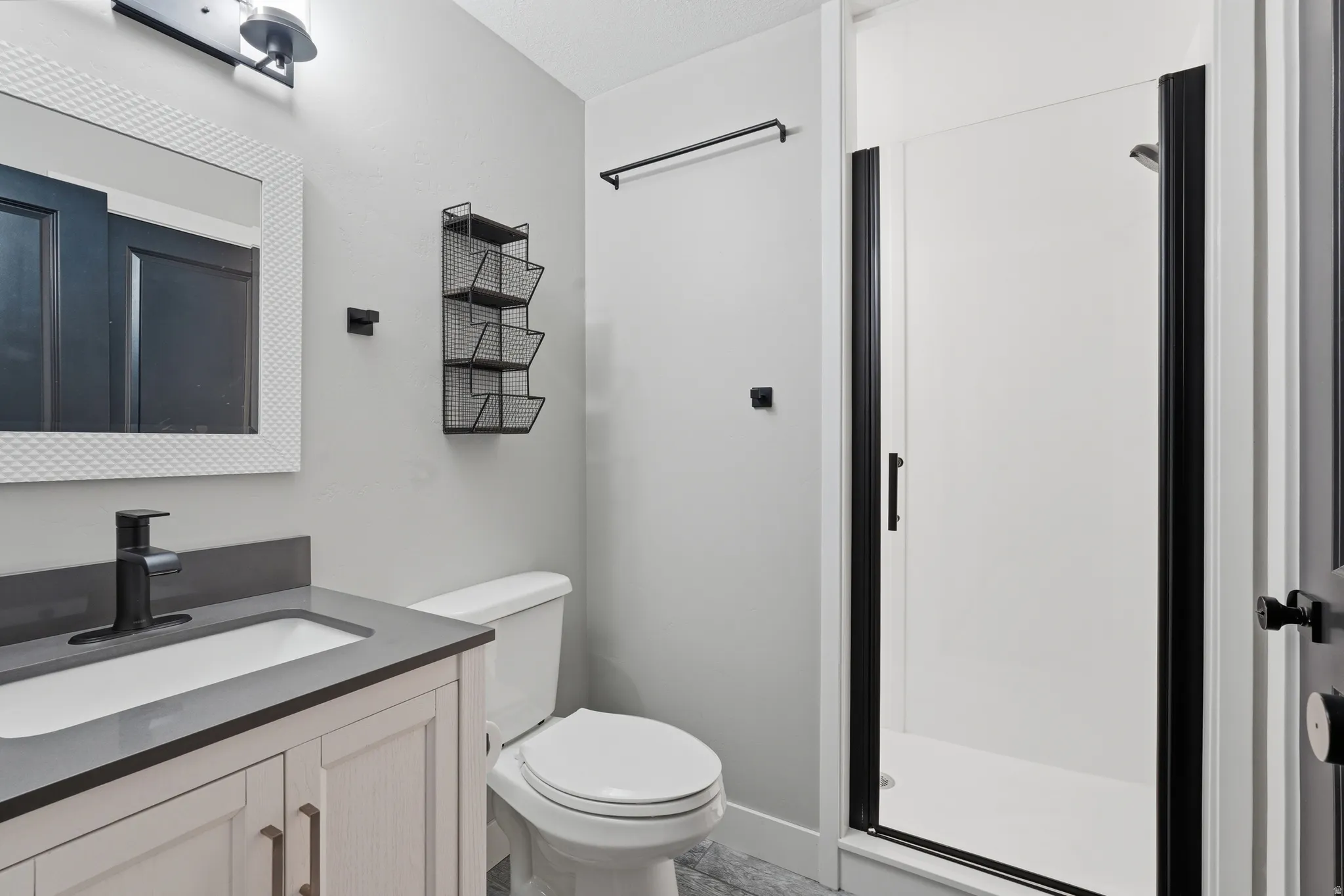 Full bath featuring vanity and a shower stall