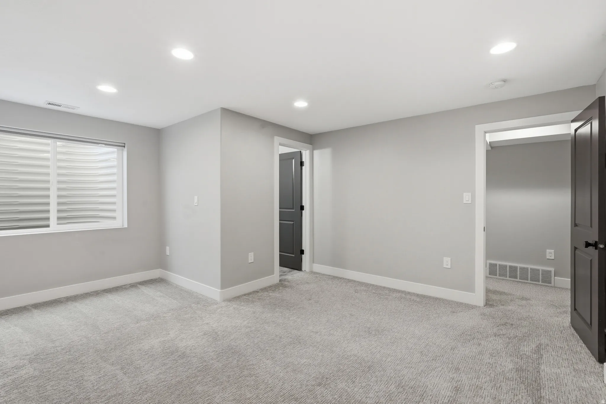 Unfurnished bedroom with recessed lighting and light carpet