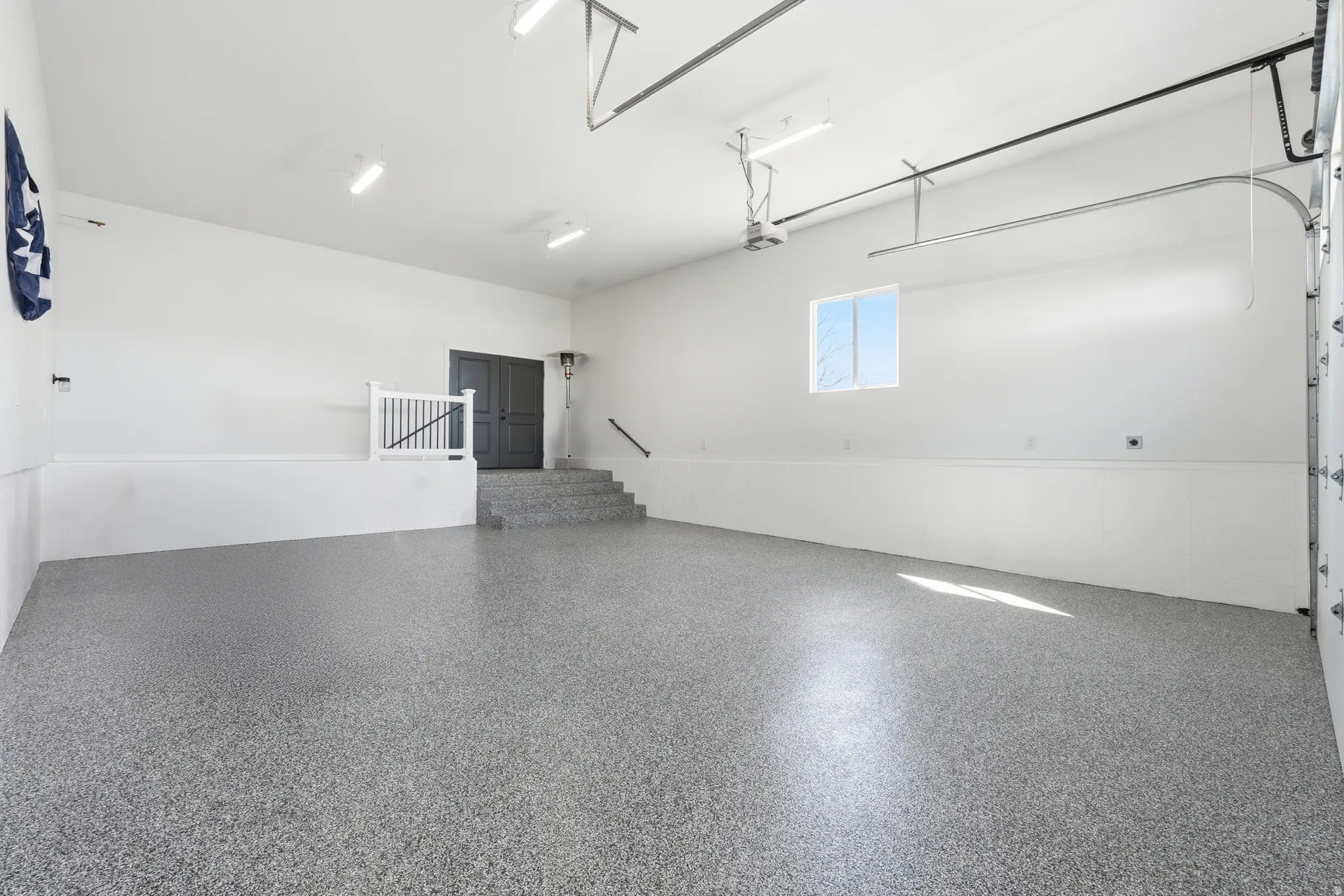 View of garage with separate entrance for basement, 220 volt outlet and stubbed for gas heater