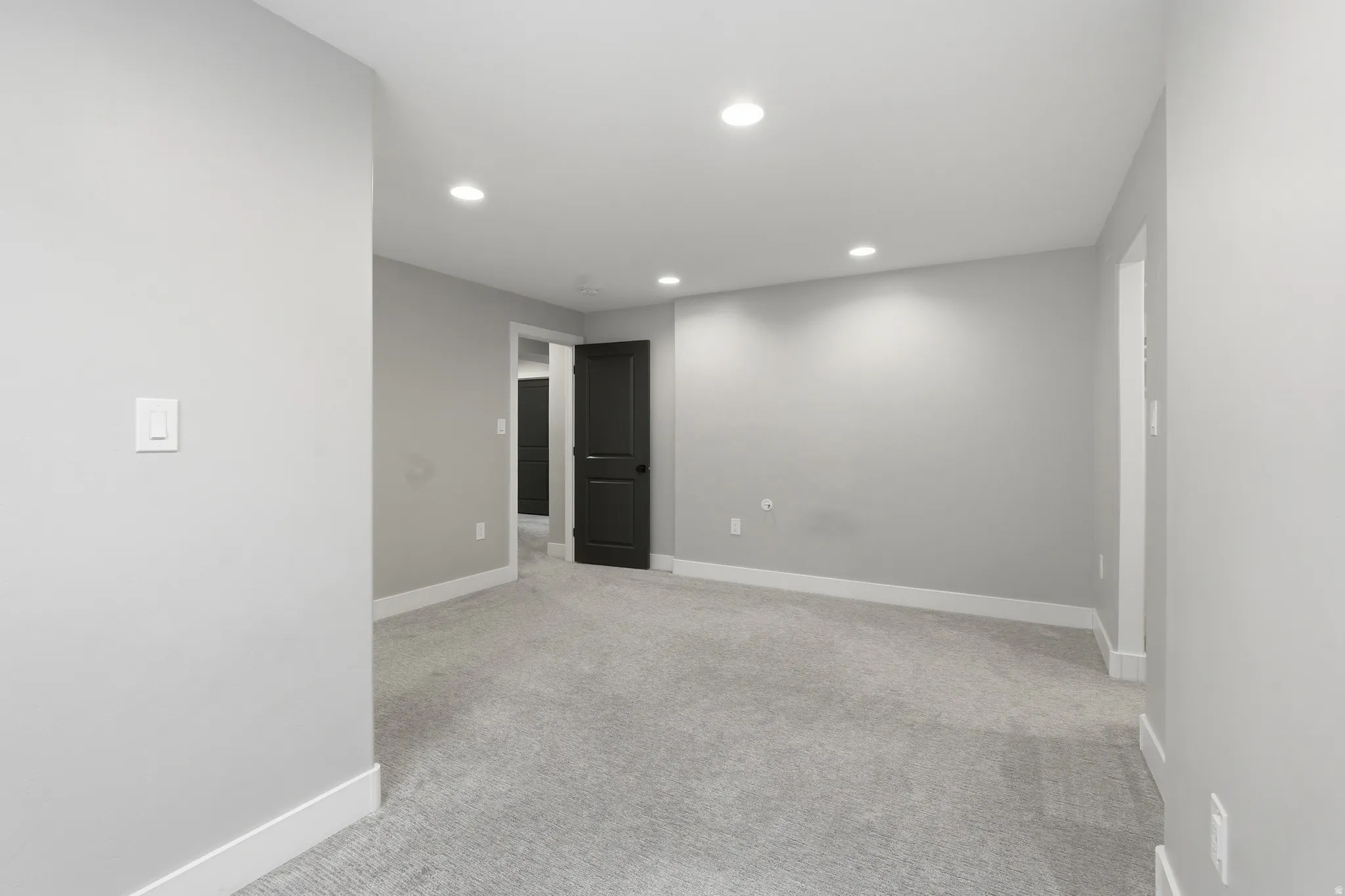 Spare room with light carpet and recessed lighting