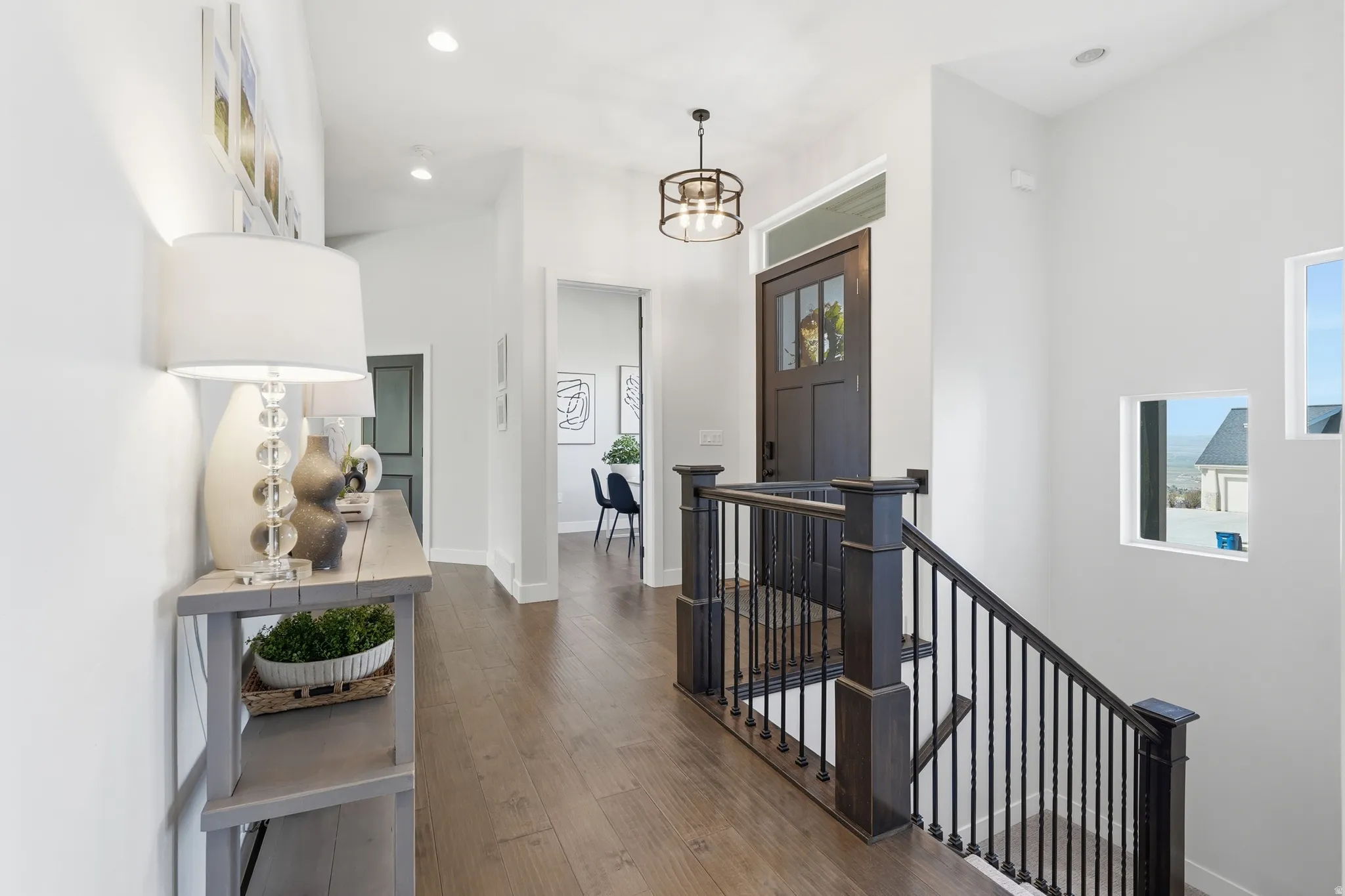 Foyer featuring hardwood flooring and hanging lights