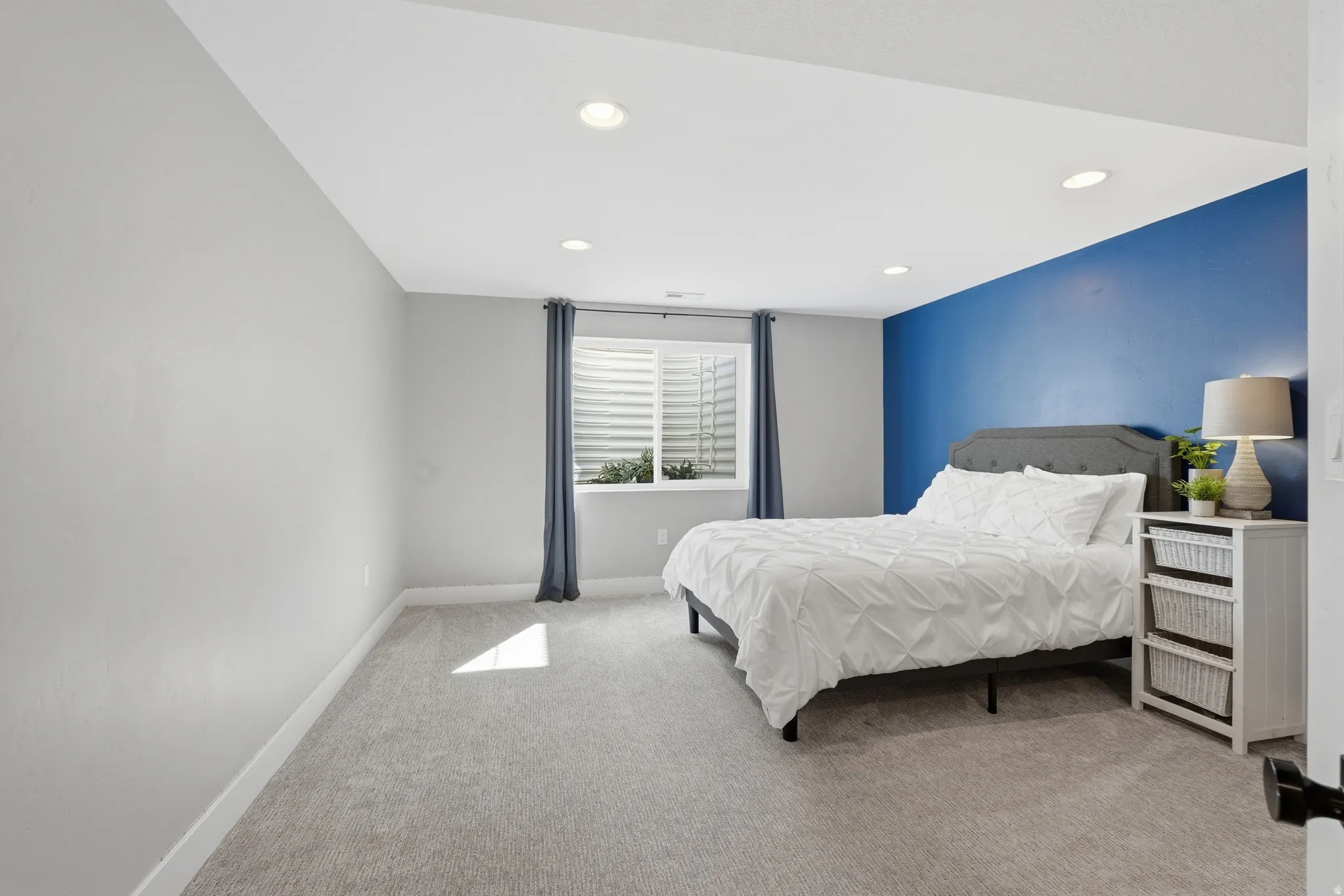 Bedroom with light carpet and recessed lighting