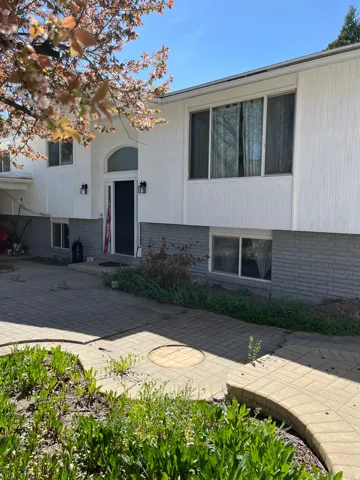 Split foyer home with brick siding and a patio area