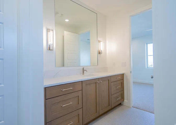 Bathroom featuring vanity and light colored carpet