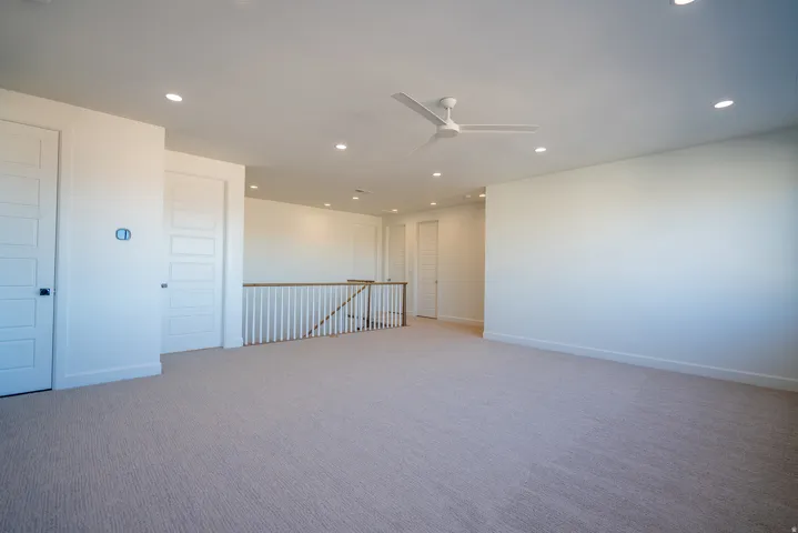 Spare room with ceiling fan, recessed lighting, and carpet flooring