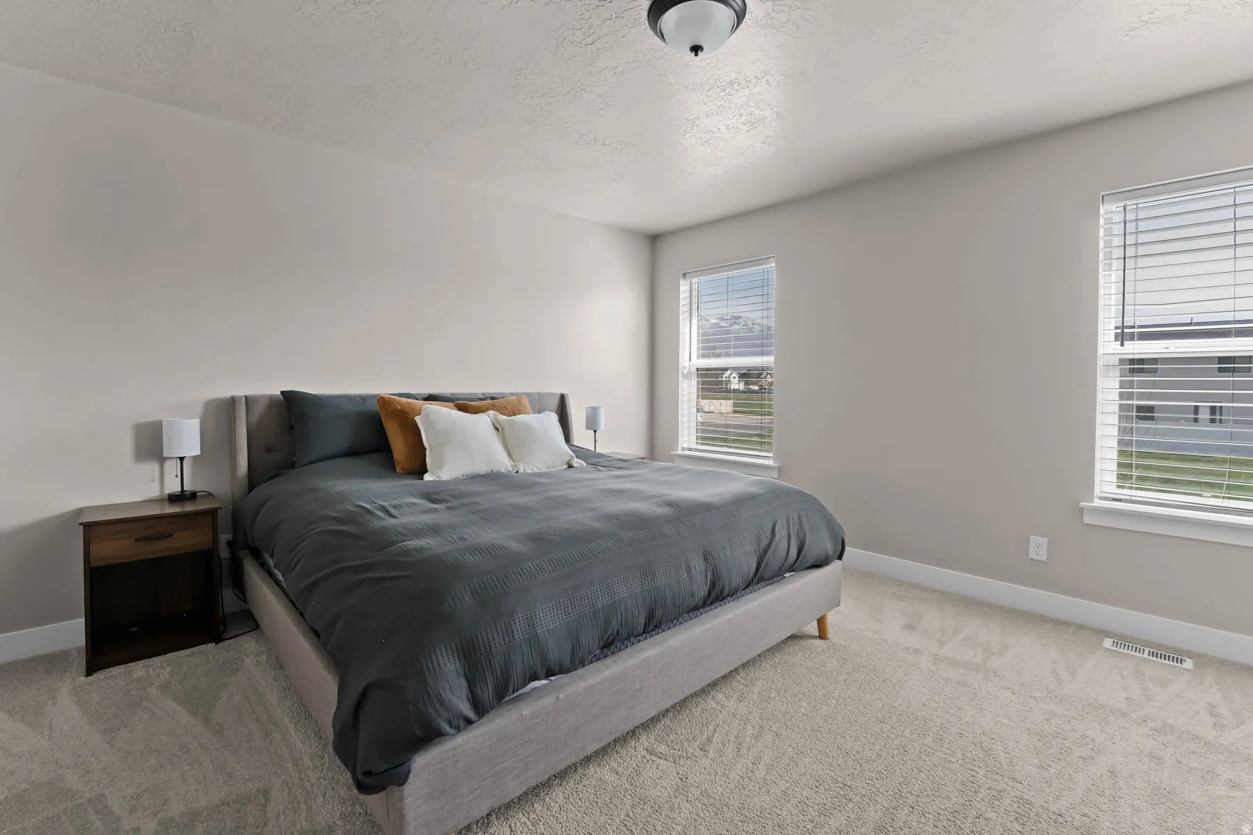 Bedroom with a textured ceiling and carpet
