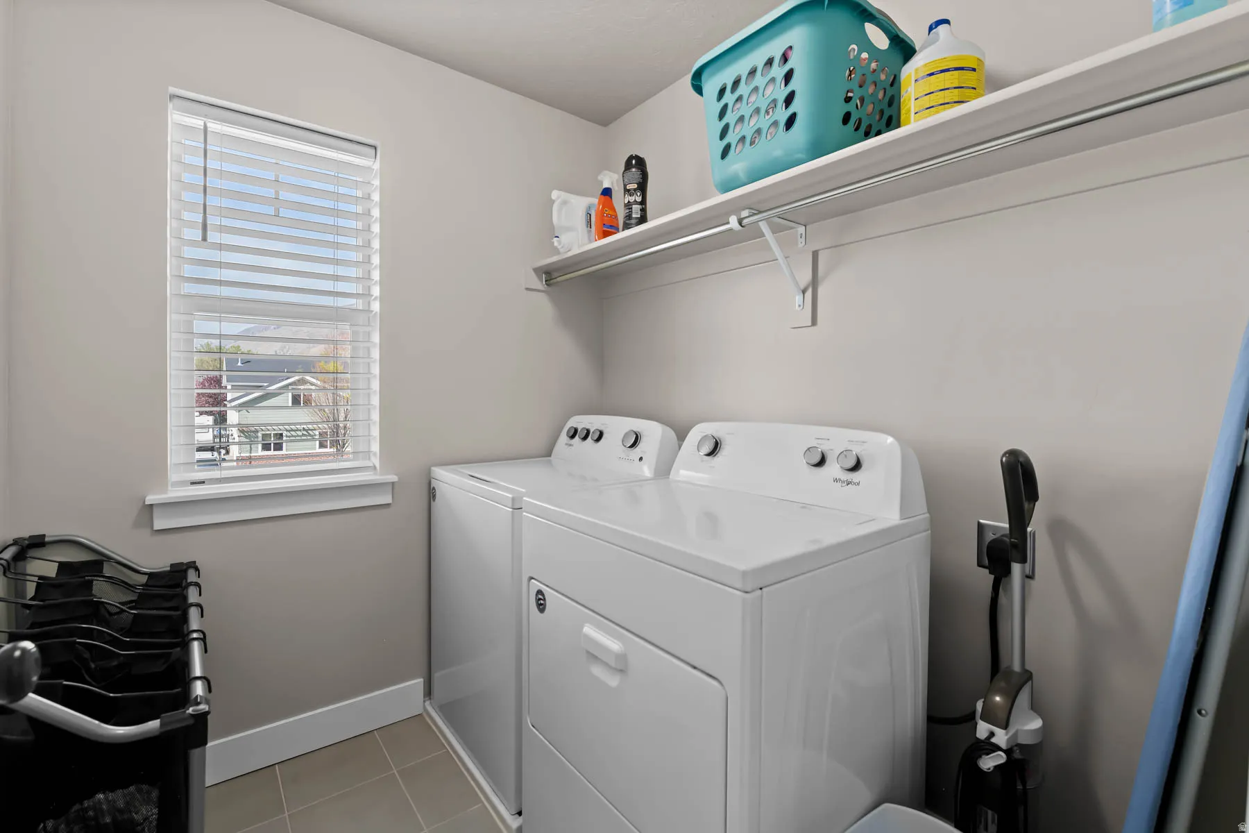 Laundry room featuring separate washer and dryer and light tile patterned floors