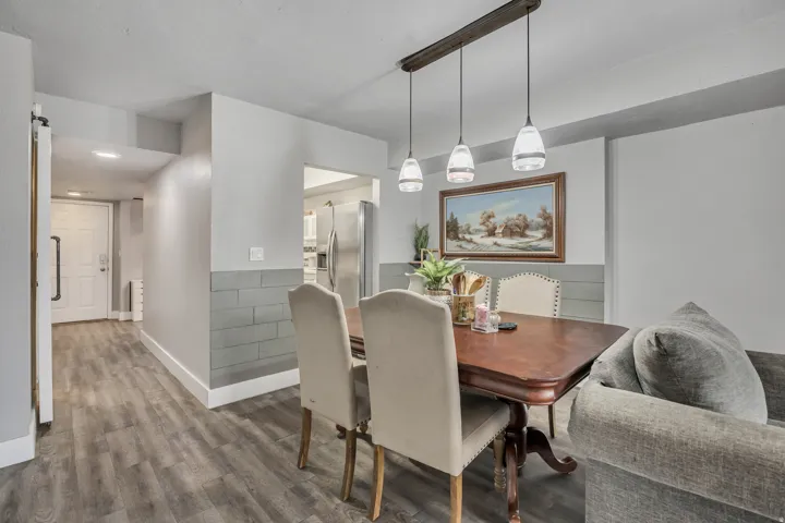 Dining room featuring dark wood-type flooring and baseboards