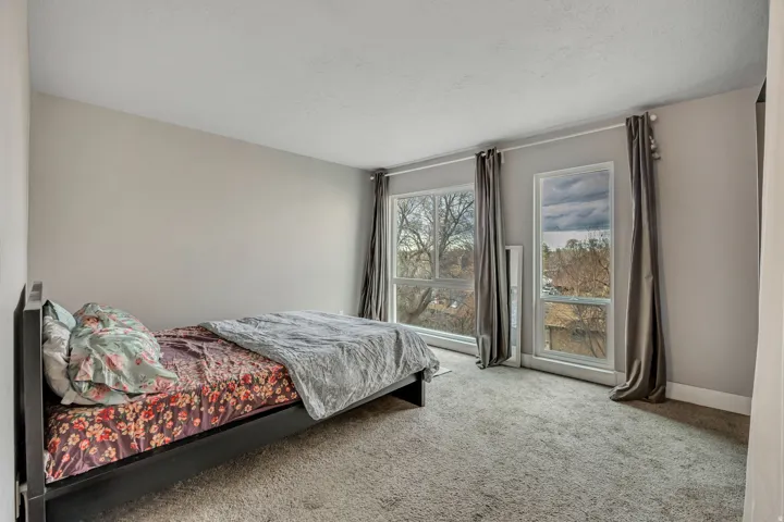 Bedroom featuring light colored carpet and baseboards