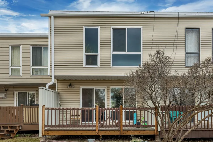 Back of property with a deck