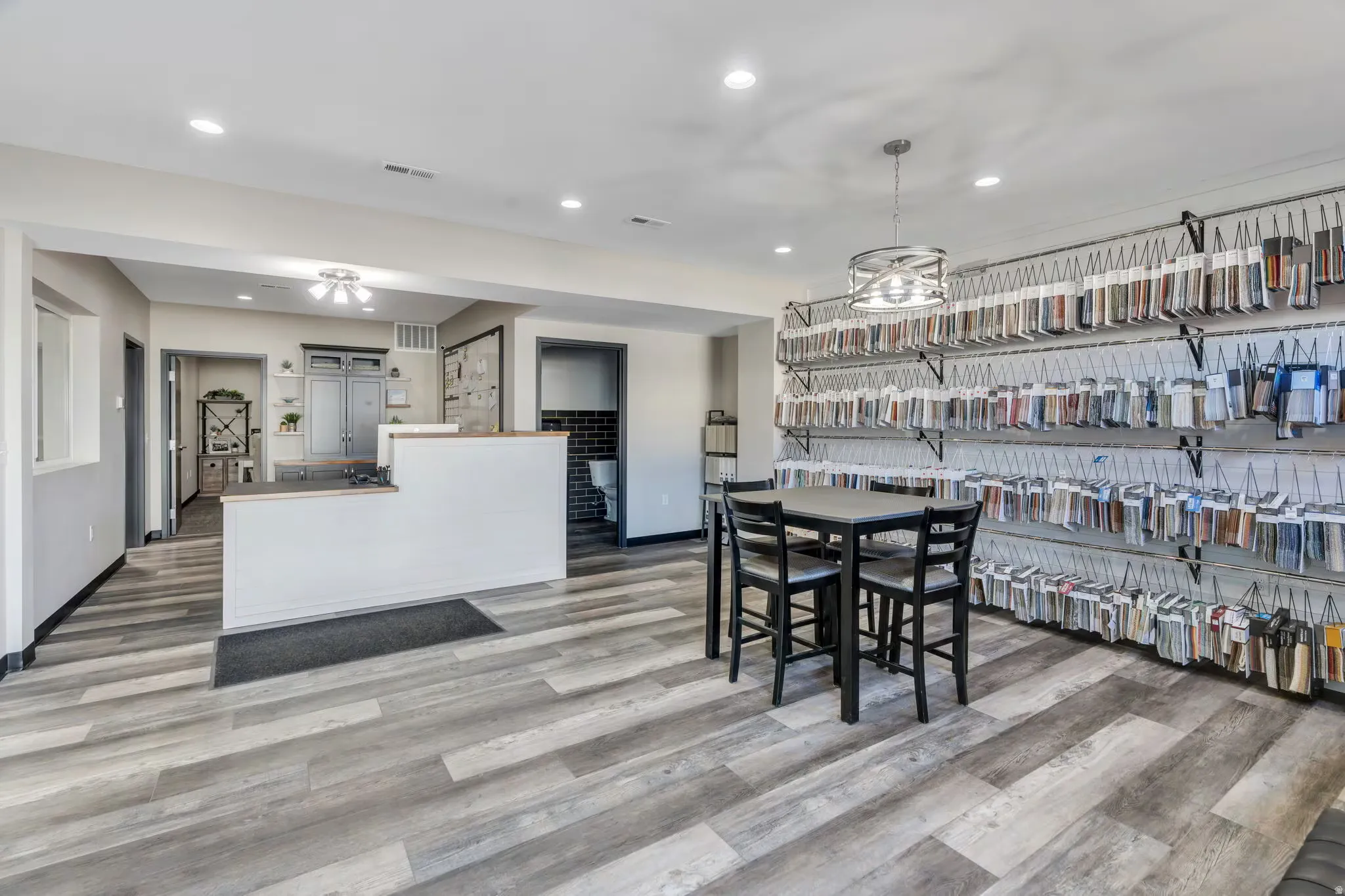 Dining area with light wood finished floors and recessed lighting