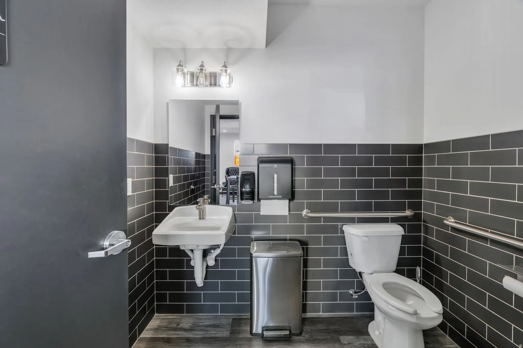 Bathroom with tile walls and wood finished floors