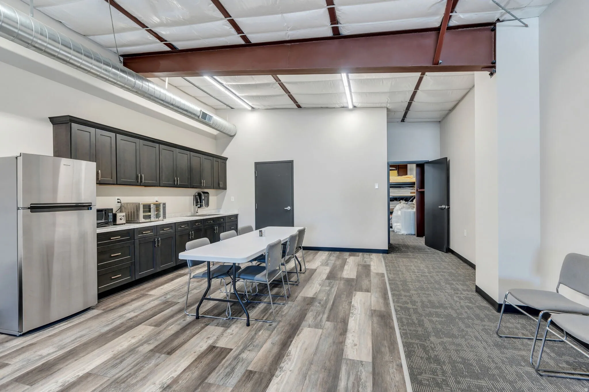Kitchen featuring freestanding refrigerator and a high ceiling