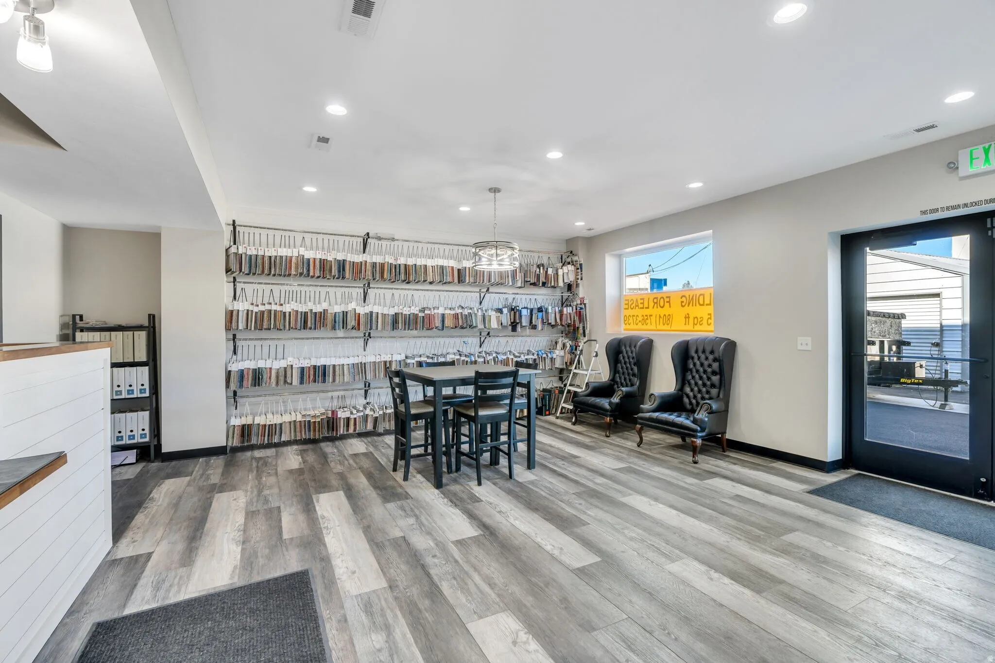 Dining room with light wood finished floors and recessed lighting