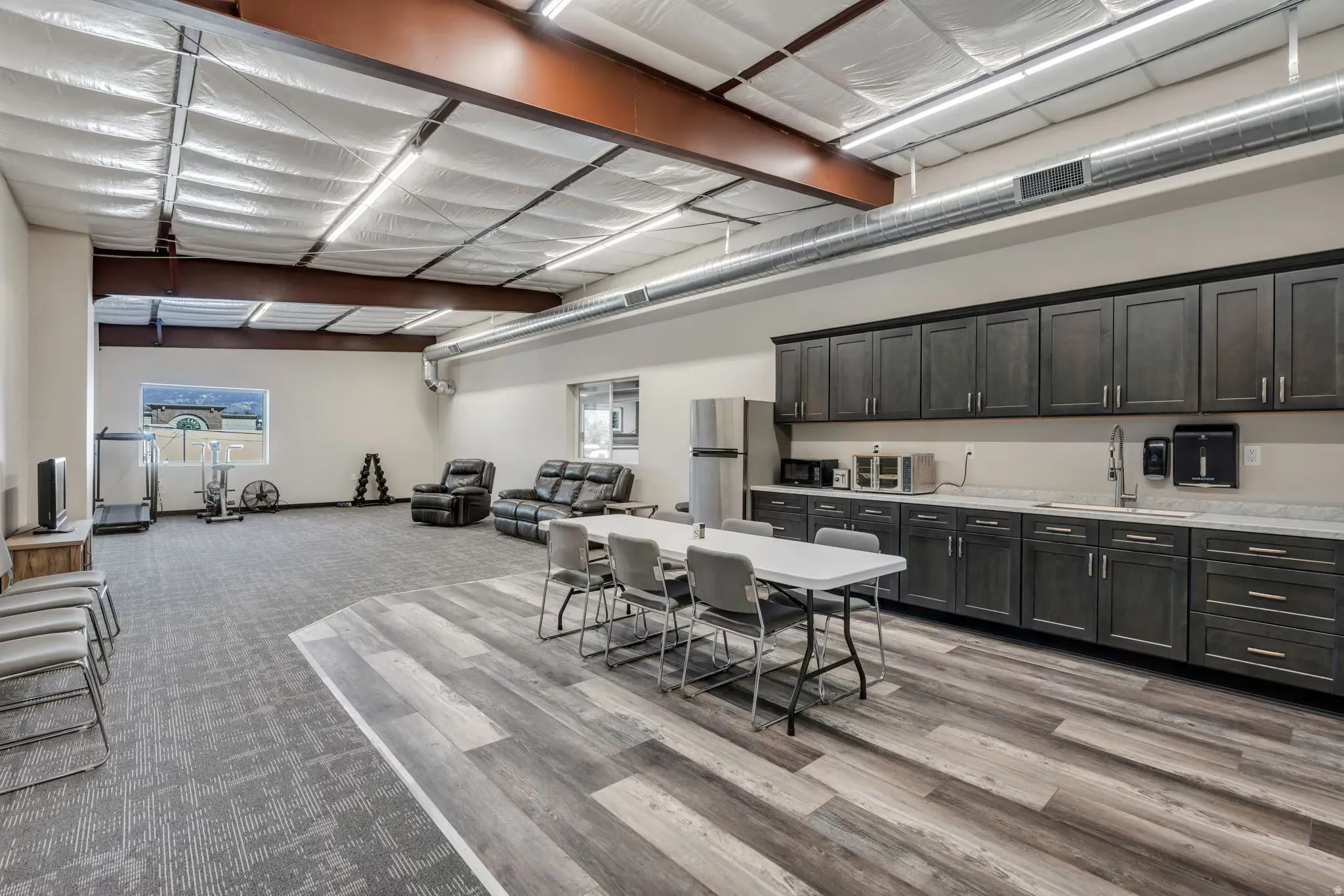 Dining space with plenty of natural light and light carpet