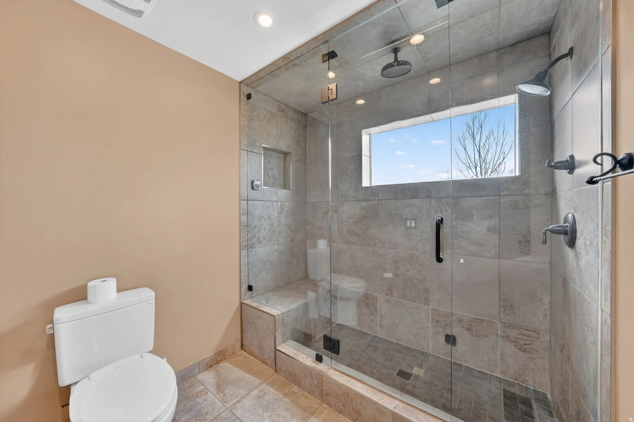 Bathroom featuring toilet and a shower stall
