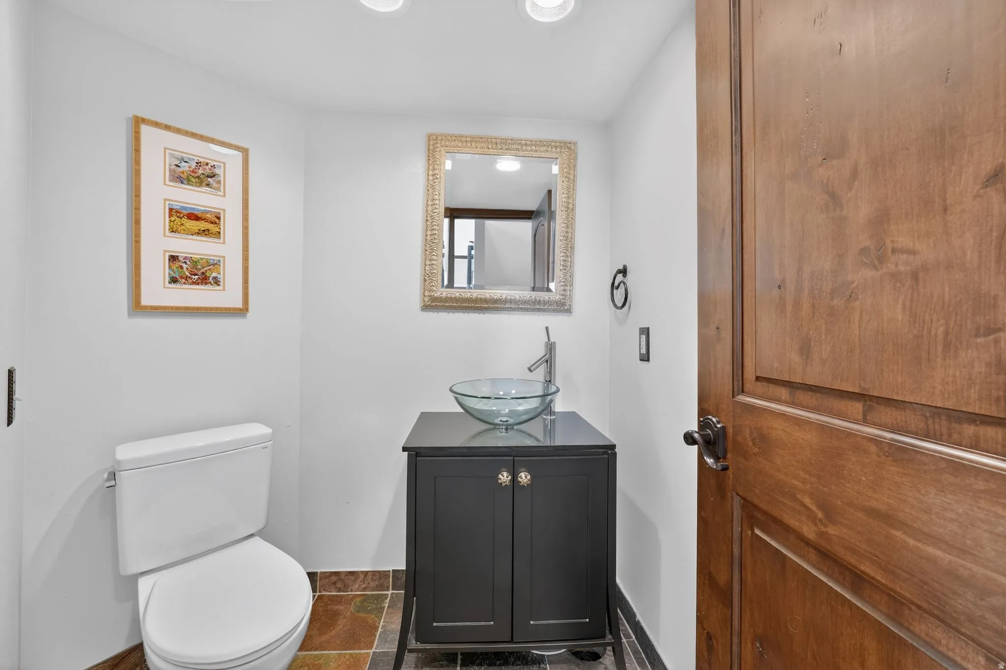 Half bath featuring vanity and recessed lighting