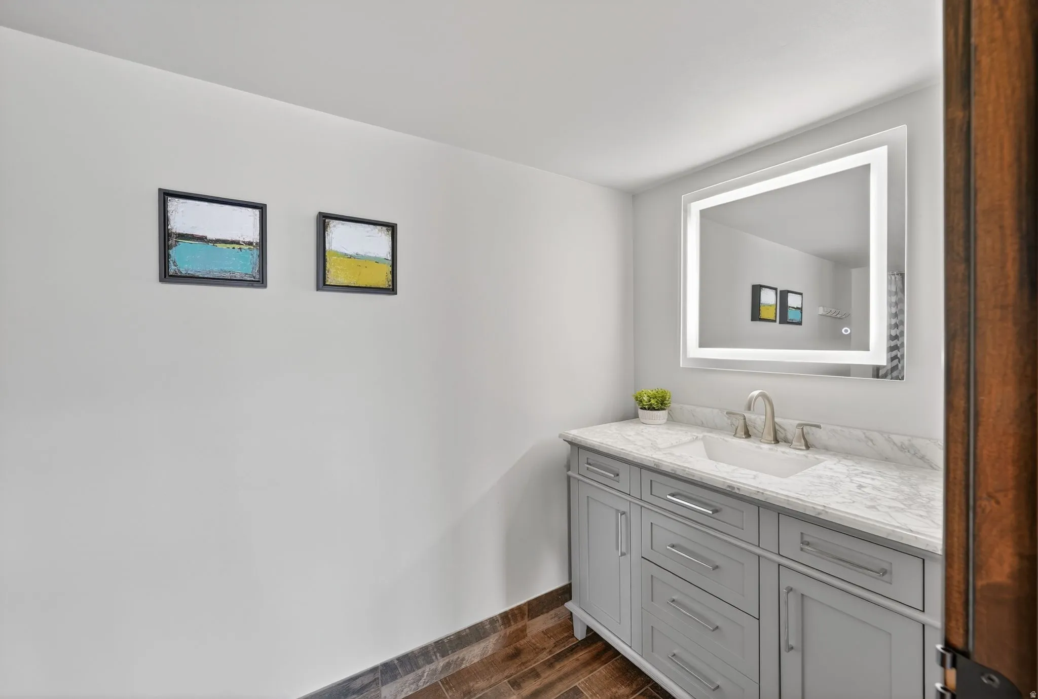 Bathroom featuring vanity and wood tiled floors