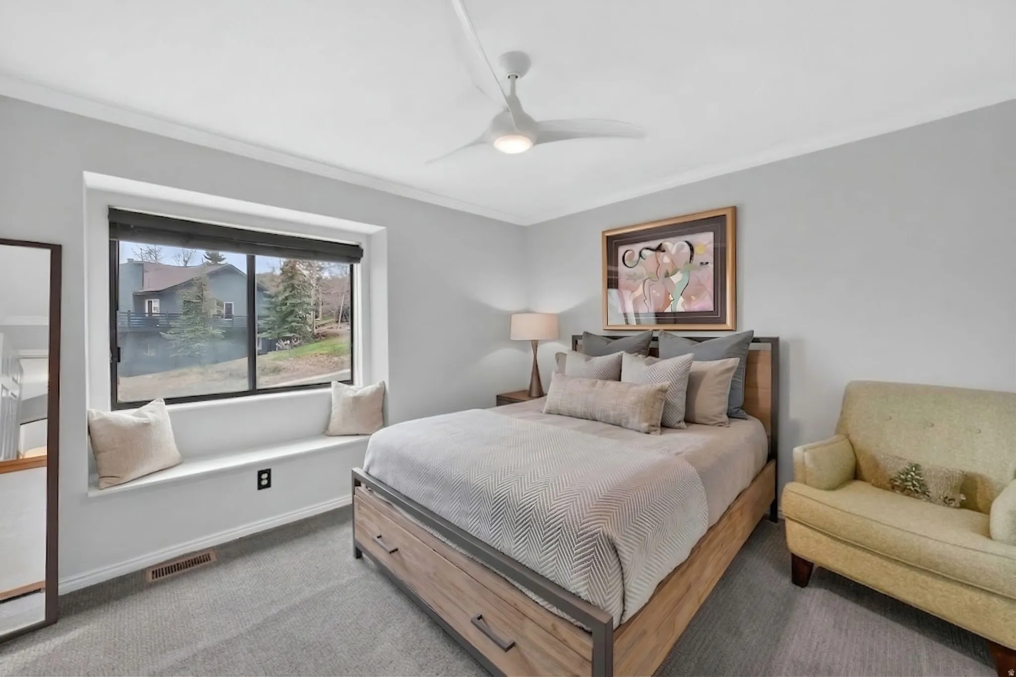 Bedroom featuring carpet, a ceiling fan, and ornamental molding