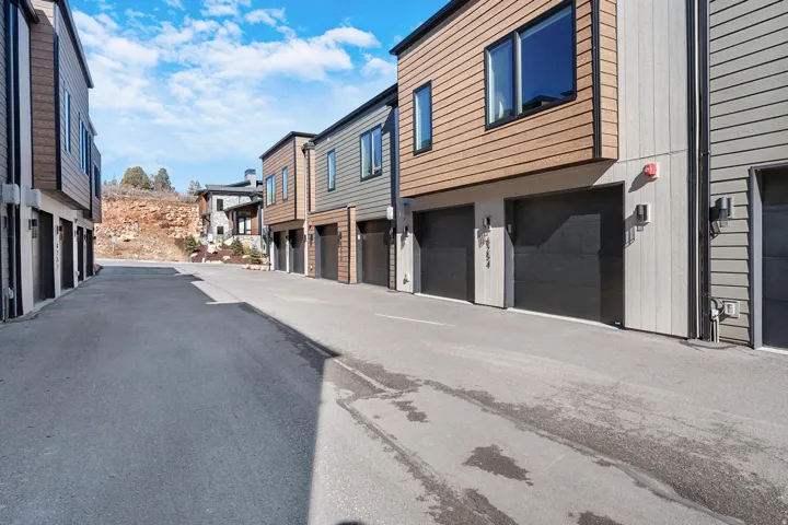 View of asphalt road featuring a residential view