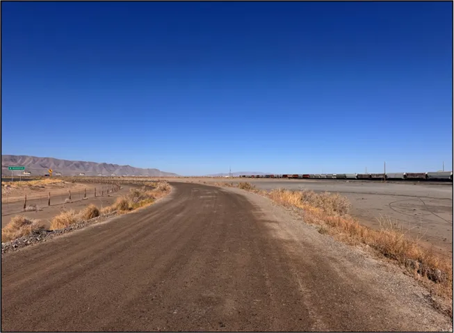 View of dirt / gravel road featuring a mountain view and a rural view