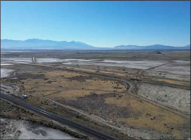 View of mountain backdrop with rural landscape and a desert landscape