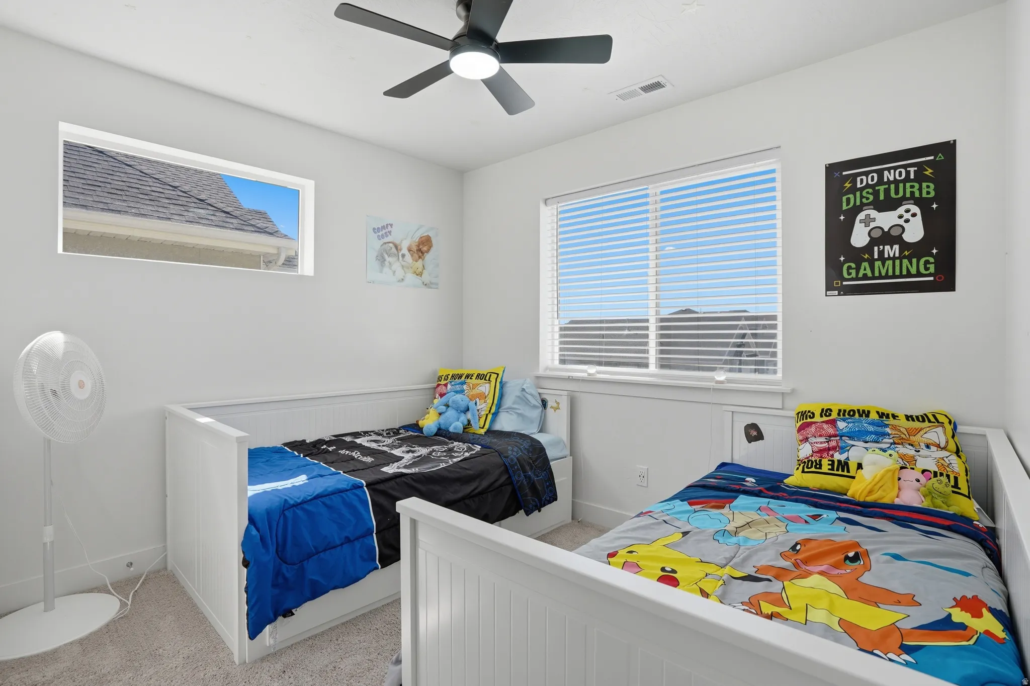 Bedroom featuring light carpet and a ceiling fan