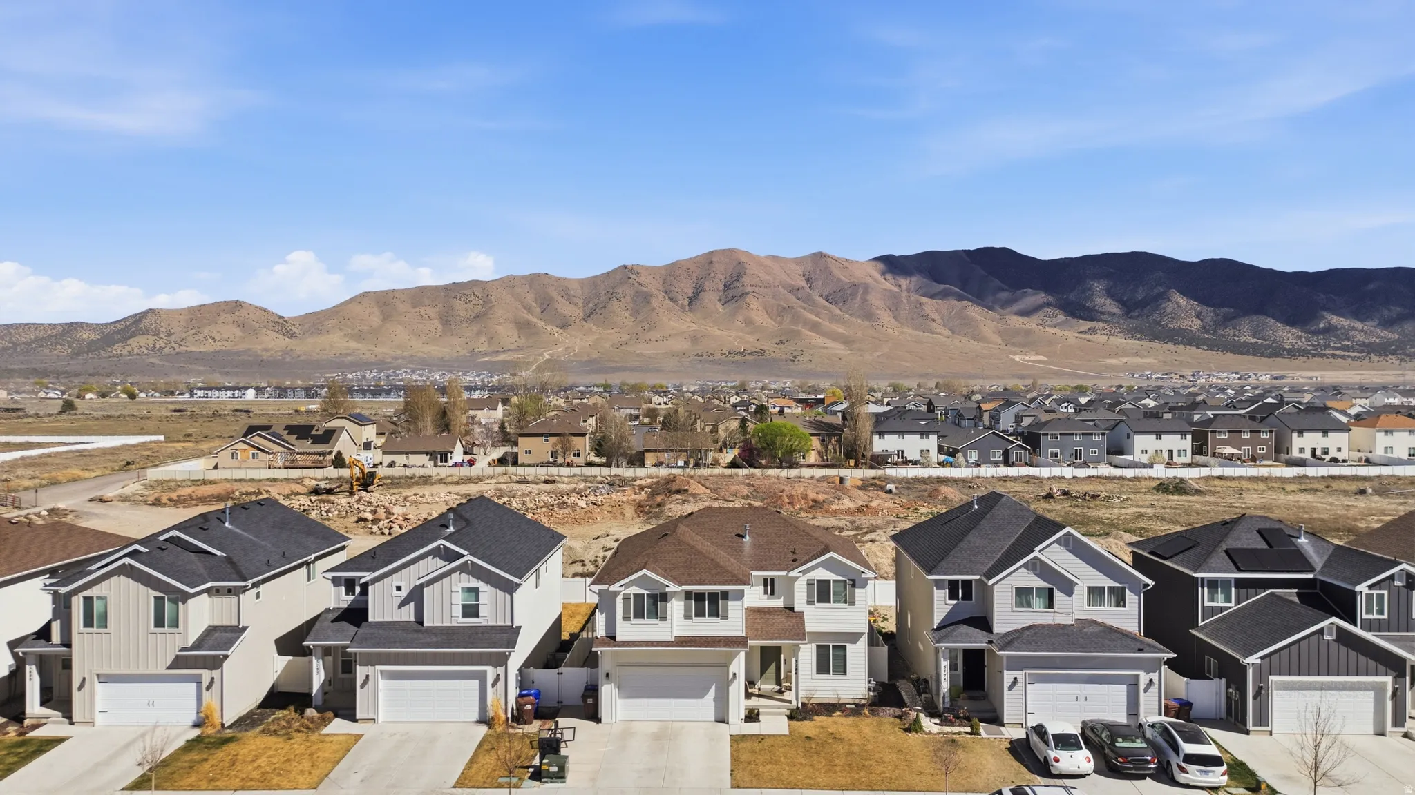 View of mountain backdrop featuring nearby suburban area
