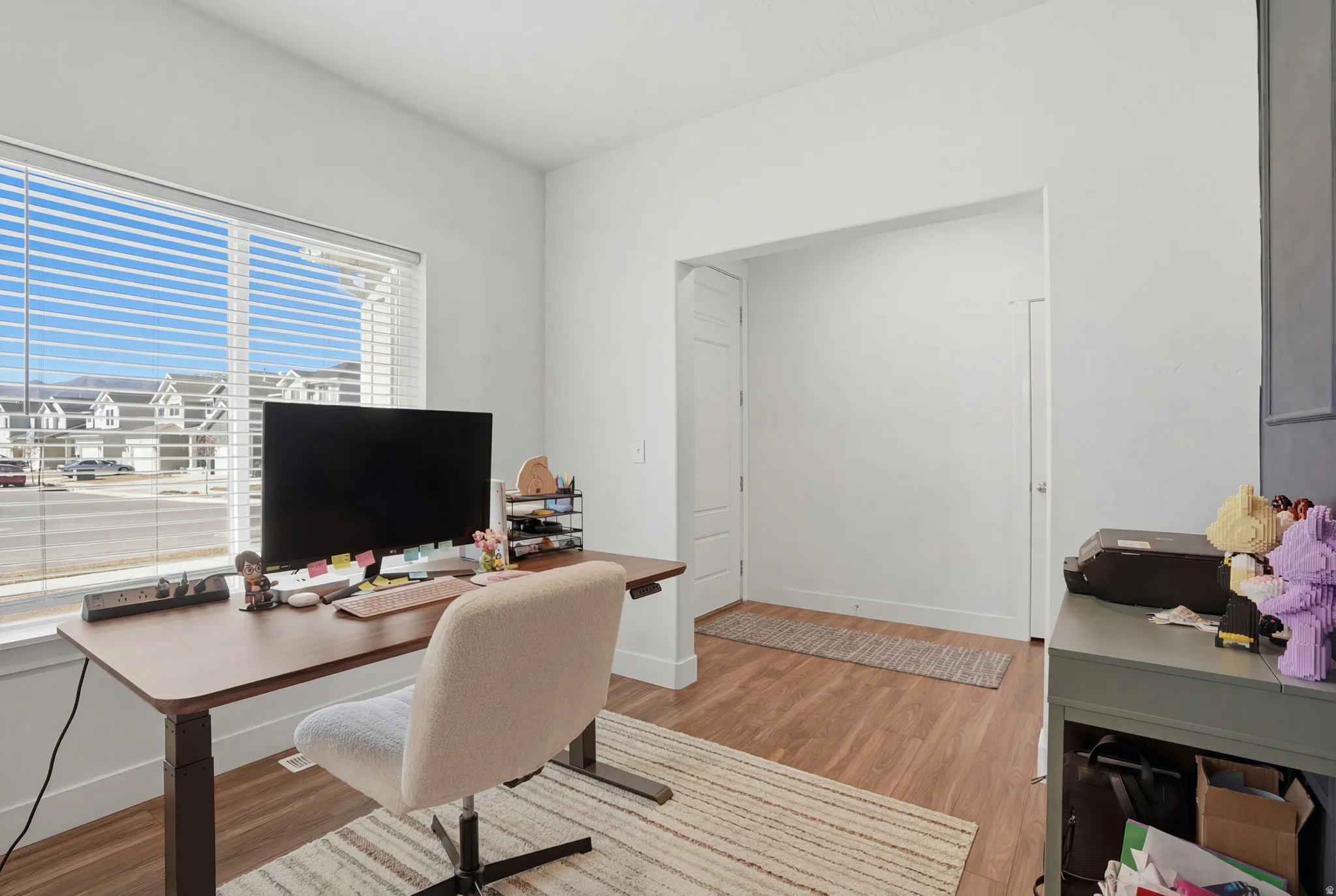 Office with light wood-style floors and baseboards
