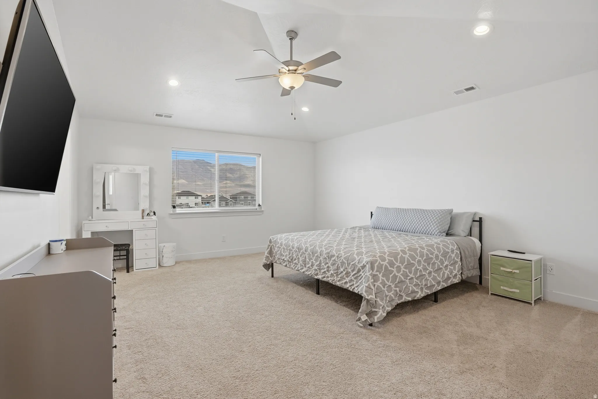 Bedroom featuring light colored carpet, a ceiling fan, and recessed lighting