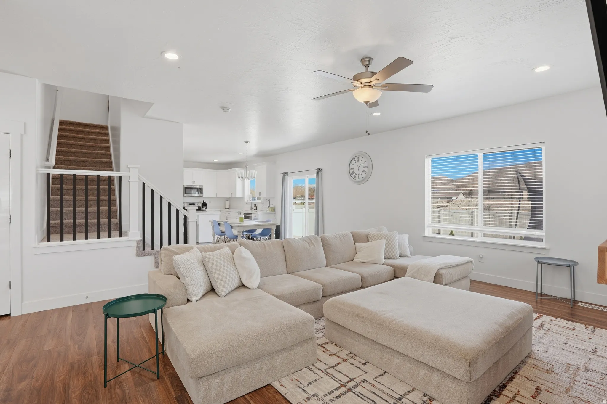 Living area featuring wood finished floors, healthy amount of natural light, ceiling fan, and recessed lighting