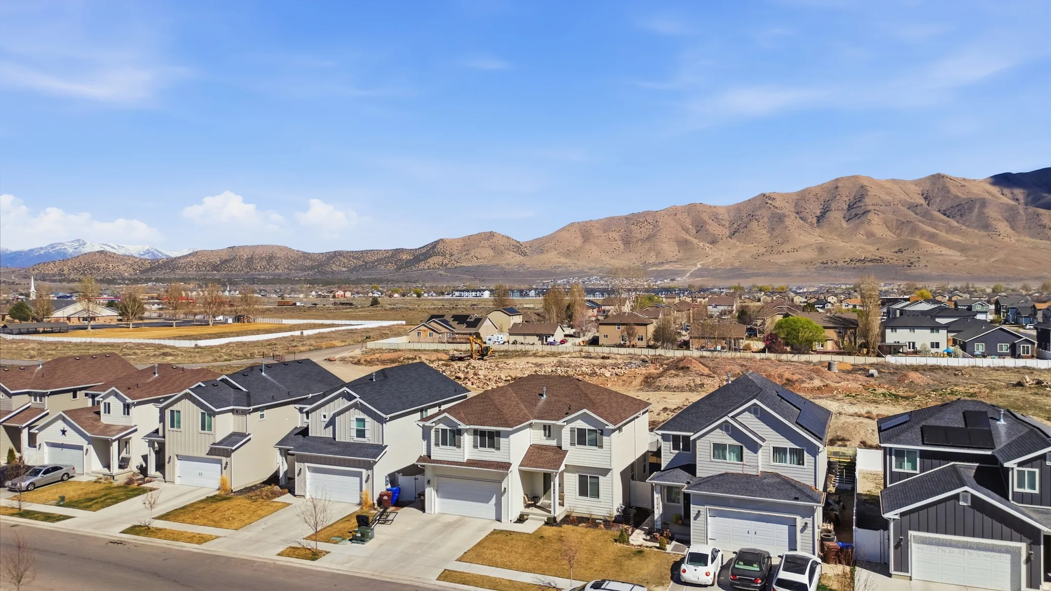 View of mountain backdrop featuring nearby suburban area
