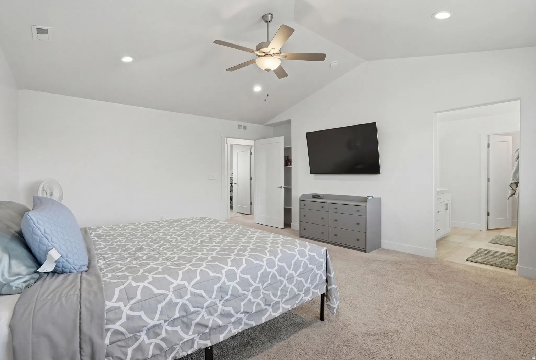 Bedroom featuring recessed lighting, light colored carpet, ceiling fan, and ensuite bathroom