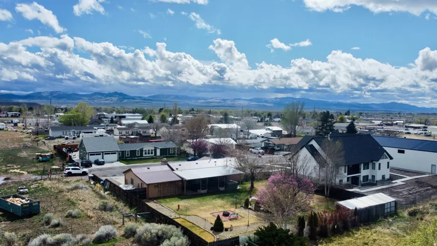 Aerial perspective of suburban area with a mountain backdrop