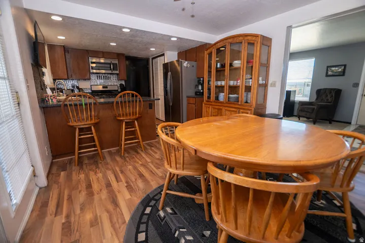Dining space featuring dark wood finished floors and recessed lighting