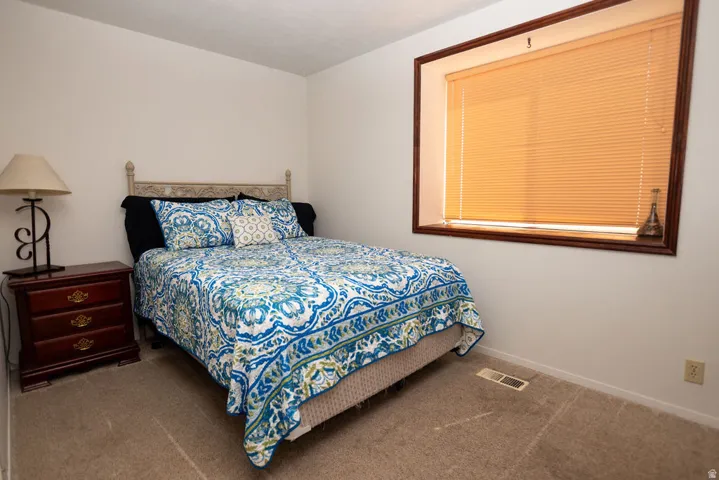 Carpeted bedroom featuring baseboards
