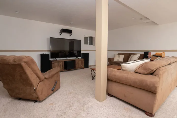 Living area featuring light carpet