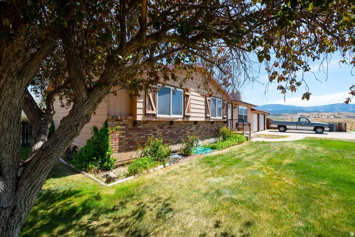Ranch-style exterior with wood siding and brick accents