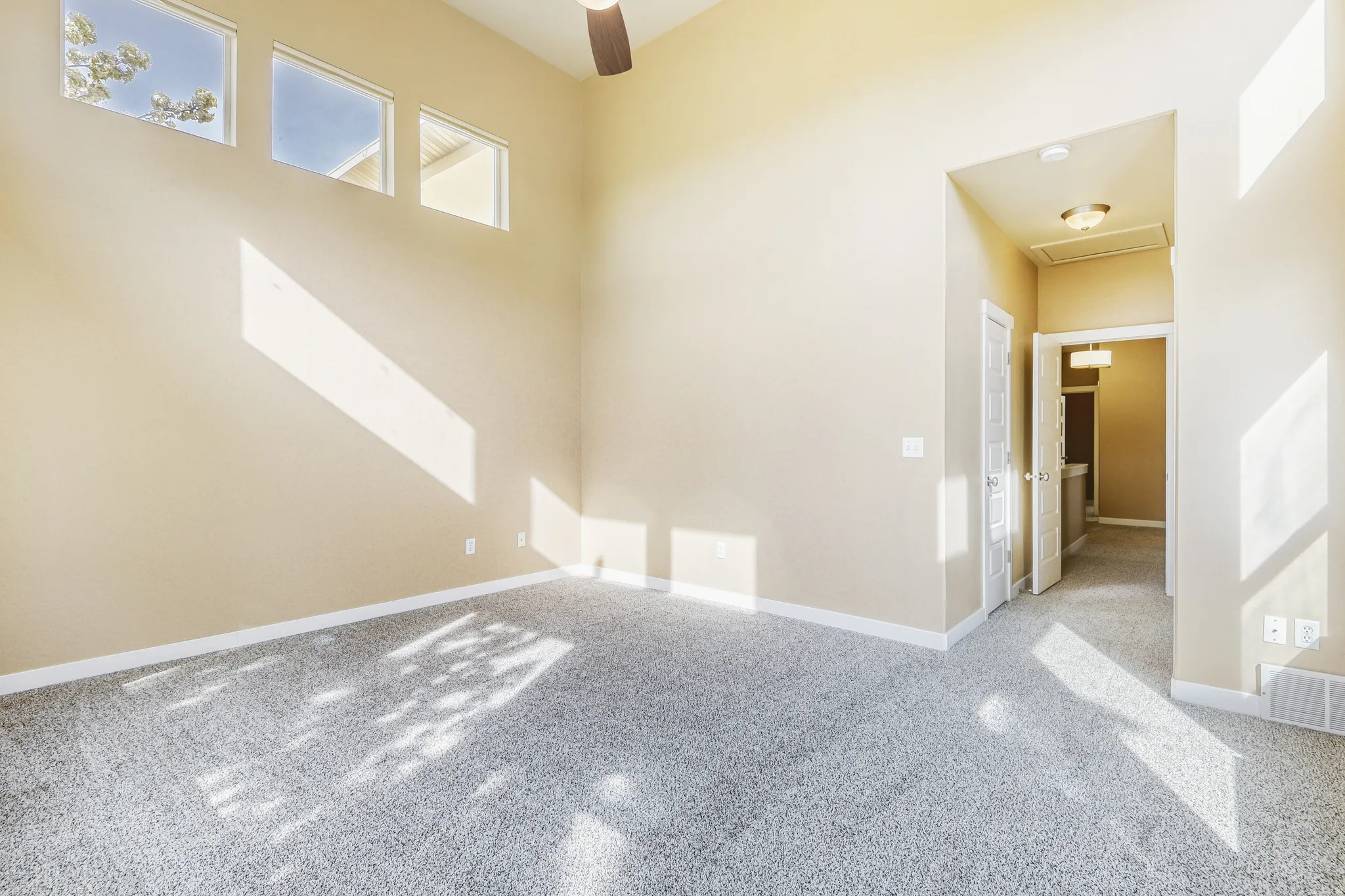 Primary Bedroom w ceiling fan and high ceiling