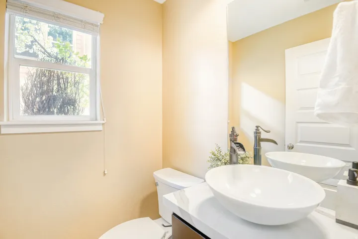 Main Level Bathroom featuring vanity and toilet