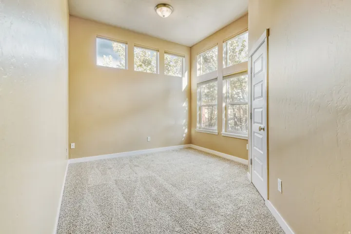 Third bedroom with high ceilings and extensive windows