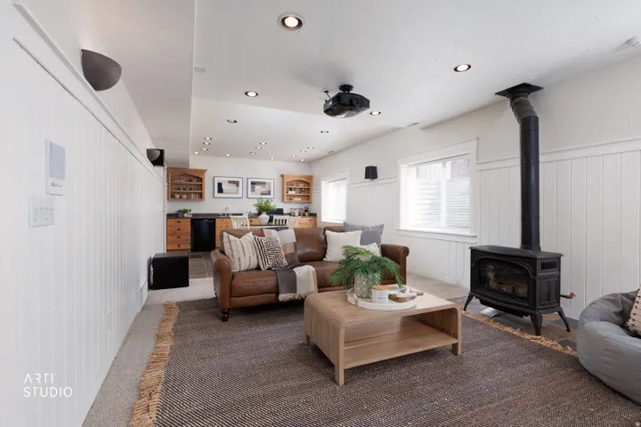 Living area with wainscoting, a wood stove, recessed lighting, wood walls, and carpet flooring