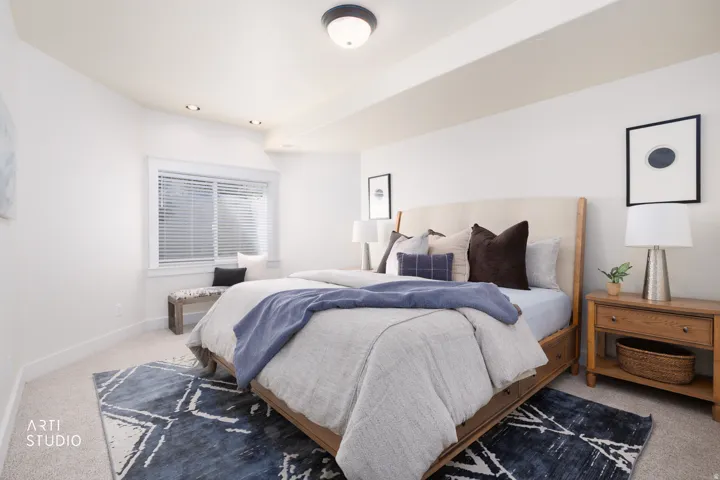Bedroom featuring light colored carpet and baseboards