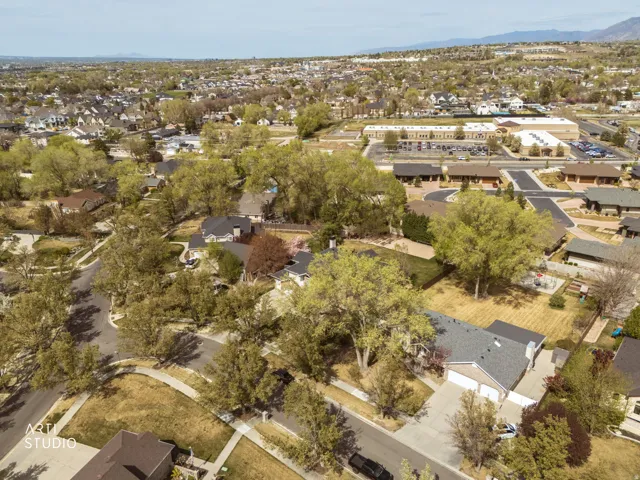 Aerial view of property's location featuring nearby suburban area and mountains