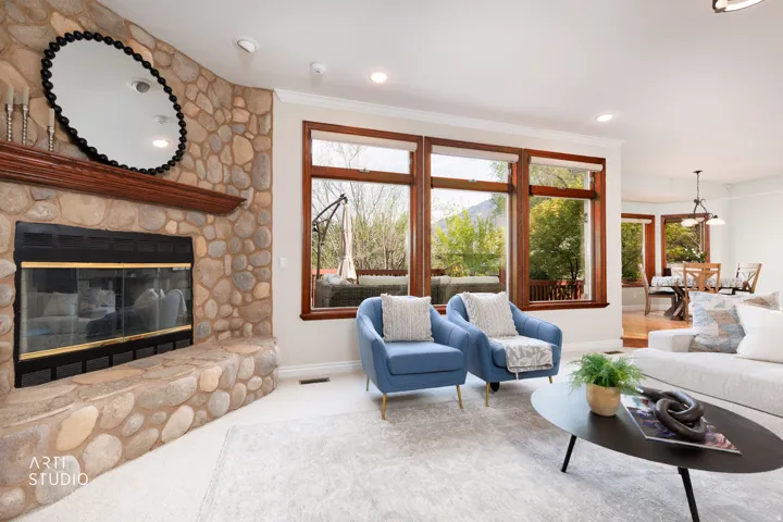 Living area with a fireplace, carpet, recessed lighting, and crown molding