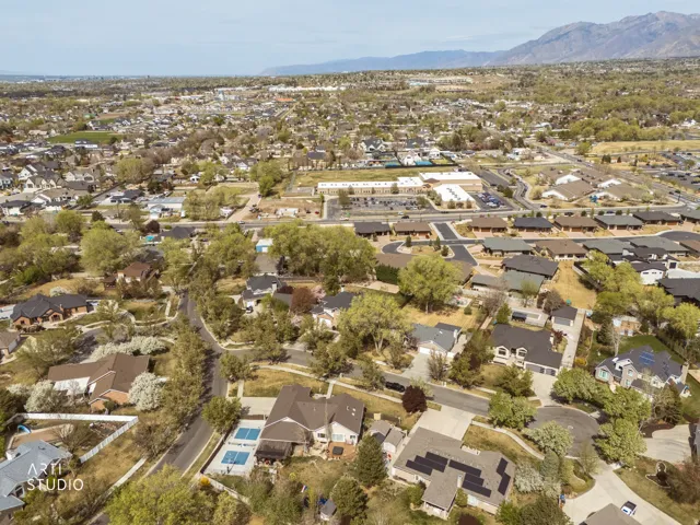 Aerial view of property's location with nearby suburban area and a mountain backdrop